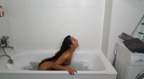 Dark haired beauty Lexi Dona lets her hair down before taking a bath