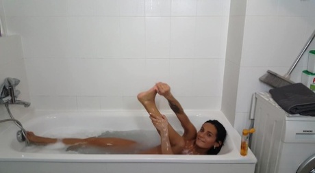 Dark haired beauty Lexi Dona lets her hair down before taking a bath