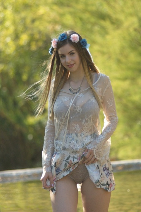 Sweet solo girl takes off her summer dress wearing a crown of flowers