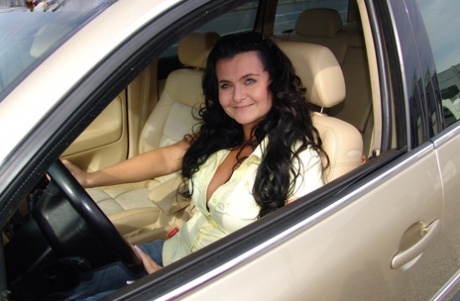 Brunette amateur Busty Reny displays her big tits while she's behind the wheel