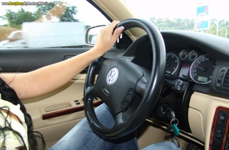 Brunette amateur Busty Reny displays her big tits while she's behind the wheel