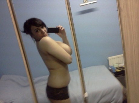 Indian BBW takes self shots in a mirror while showing her huge breasts