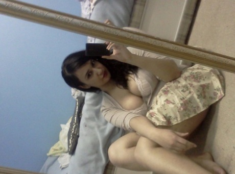 Indian BBW takes self shots in a mirror while showing her huge breasts