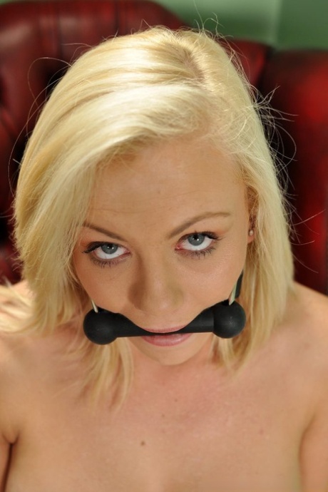 Topless blonde Sarah Jane sports a gag while wrist and ankle bound