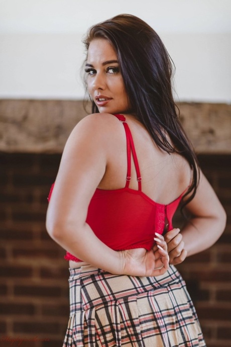 Hot British girl Kym Graham crosses her legs before loosing her big boobs