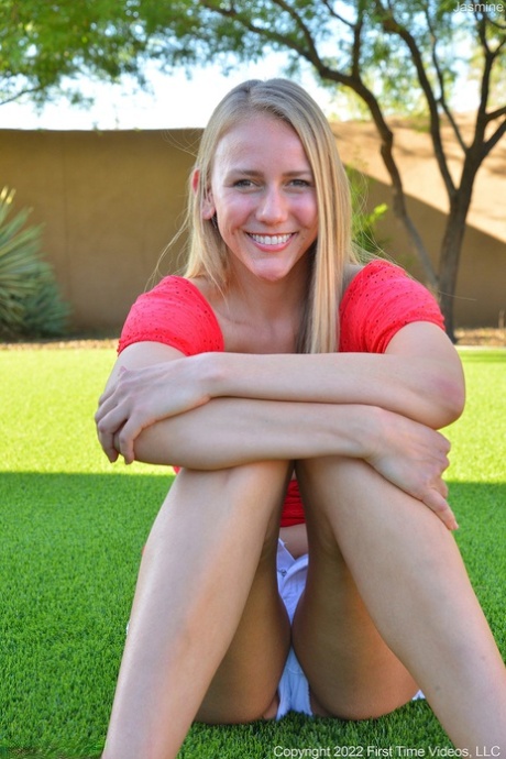 Natural blonde Jasmine masturbates with a sex toy in a backyard