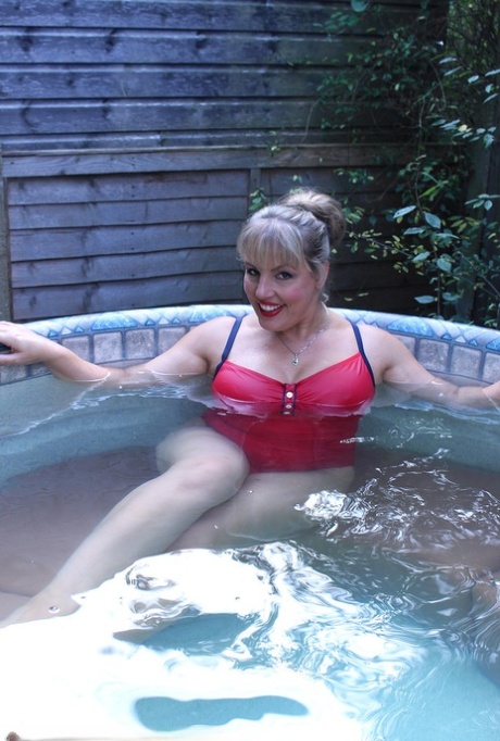 Hot fatty mature Danielle T sheds swimsuit to pour cold water on her big tits