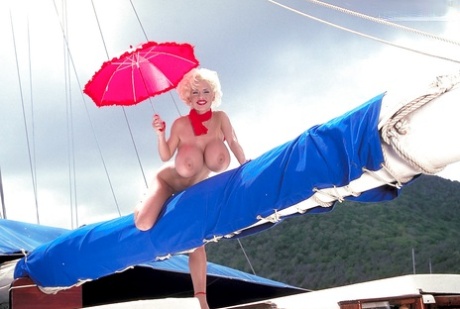 Platinum blonde pornstar SaRenna Lee loosing hooters outdoors on houseboat