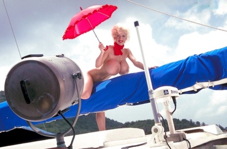 Platinum blonde pornstar SaRenna Lee loosing hooters outdoors on houseboat