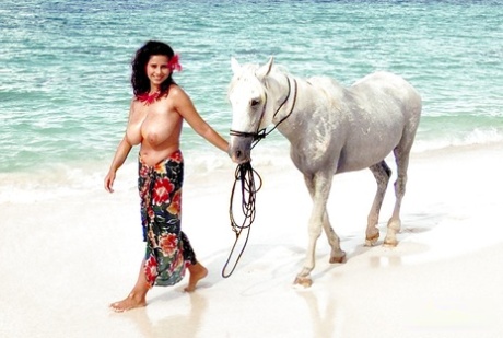 European solo model Chloe Vevrier demonstrating hooters in ocean and on beach