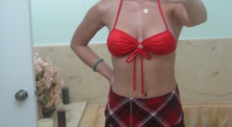 Asian female Lisa Ly takes topless selfies in bathroom mirror