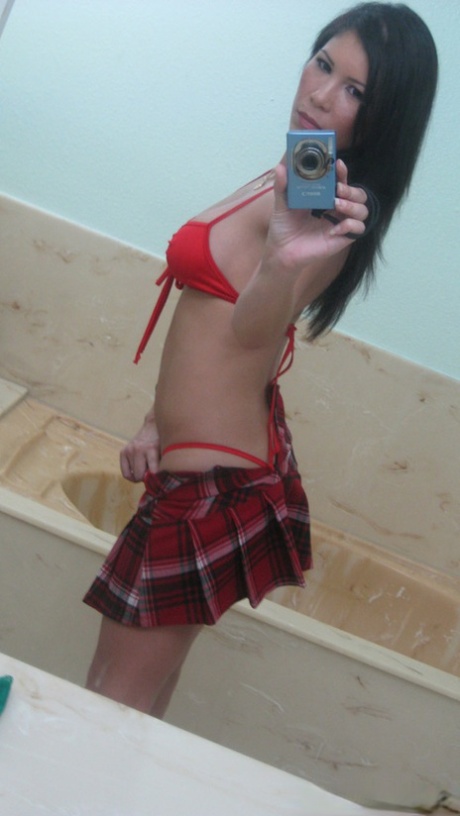 Asian female Lisa Ly takes topless selfies in bathroom mirror