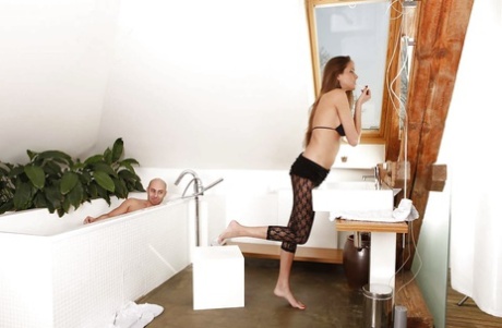 Sweet european babe in pantyhose gets her bare feet licked in the bath