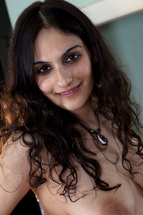 Lovely amateur babe Riani showcases her big saggy tits and hairy body parts