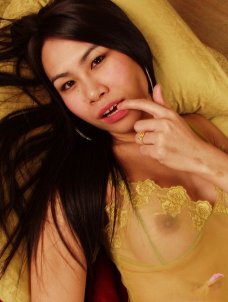 Cute Asian shemale Nan exposes her fake tits & masturbates solo on her bed