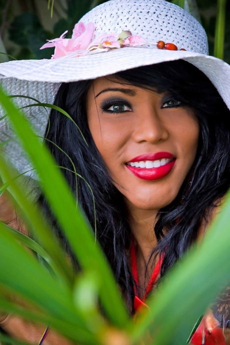 Kinky tranny Areeya exposes her big tits & poses in hot red fishnets outdoors