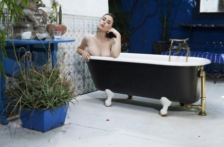 Glamorous babe Olive Glass washes her juicy tits and furry muff in the bathtub