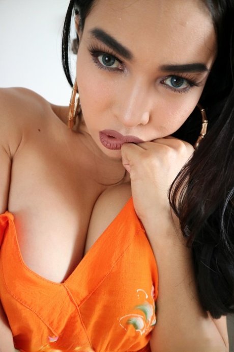 Gorgeous dark haired shemale Filipina flaunts her beautiful boobs
