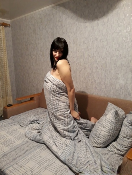 Sensational MILF amateur reveals her huge juggs and poses naked on a sofa bed