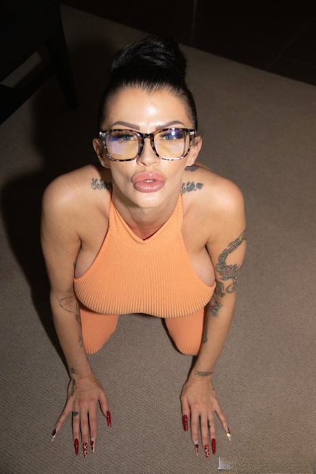 Curvaceous MILF Joslyn James teases with her big tits in a jumpsuit & heels