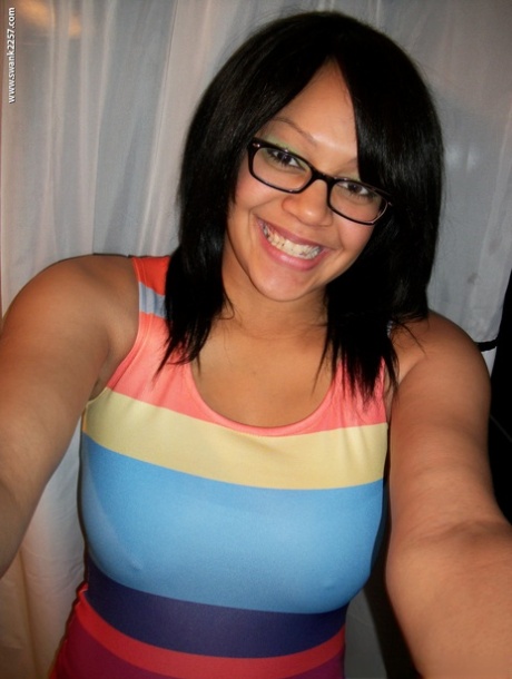 Sweet amateur girl in glasses Krista T unveils her big suckable tits and poses