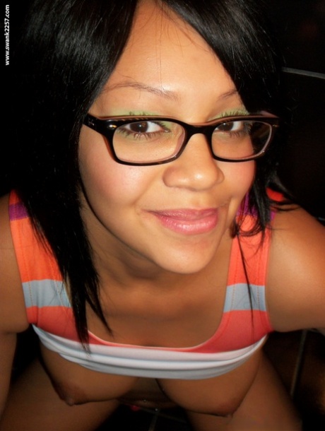 Sweet amateur girl in glasses Krista T unveils her big suckable tits and poses