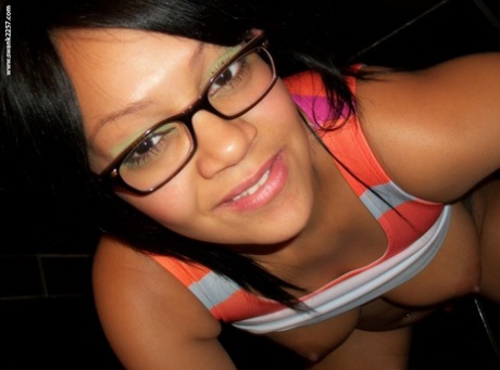 Sweet amateur girl in glasses Krista T unveils her big suckable tits and poses