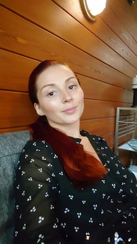 Gorgeous redhead shows off her big tits & her tattoos while taking nudes