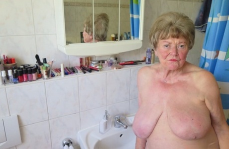 Shy granny Phyladelphia playing with her huge saggy tits in a solo