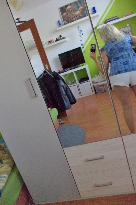 Stunning older woman Sindy H exposes her huge bosom and plays with a toy