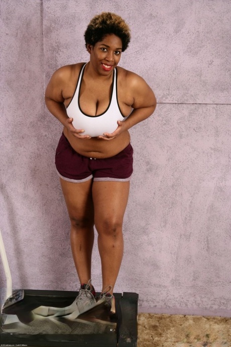 Chubby ebony Misty lets out her huge melons and flaunts her hairy twat