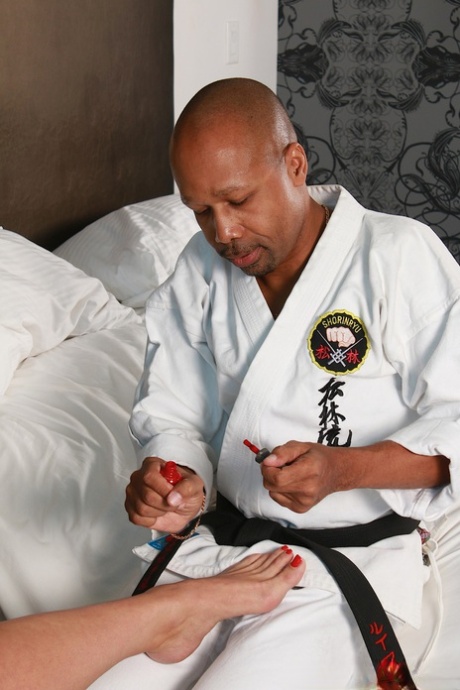 Busty slut Alura Jenson gives a karate master a footjob and fucks his BBC