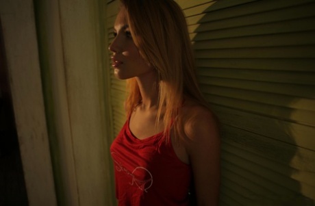 Petite blonde hottie Bendy teasing with her nice fake tits in the window